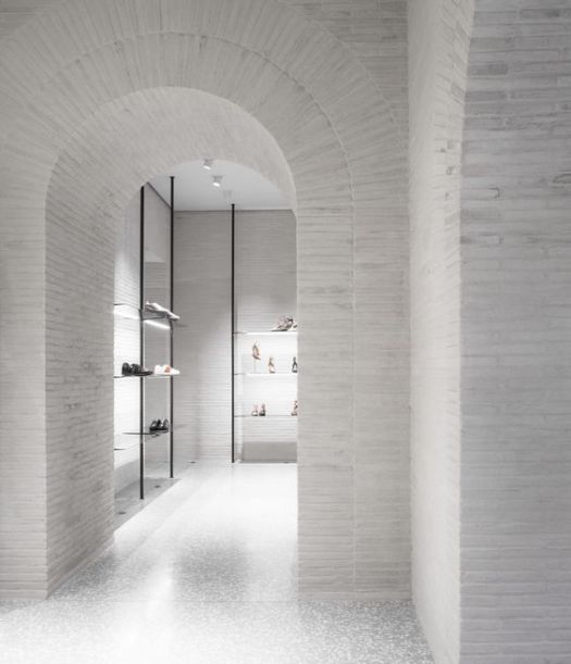 White interior with white wash brick arch minimalist store
